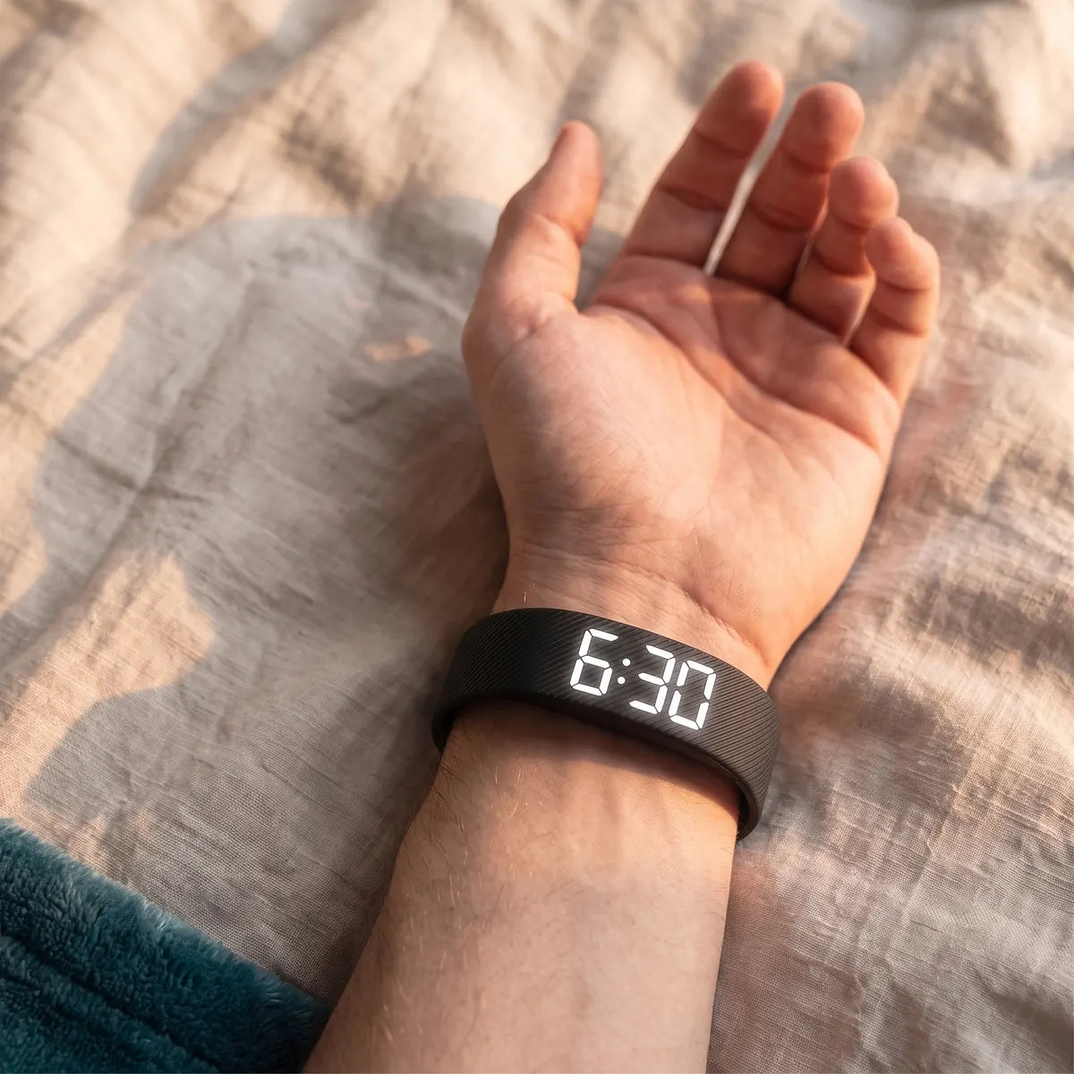 The Touchwake band worn with its display on the inside of the wrist, palm up, reading 6:30